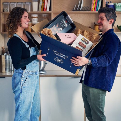 Lucie and Tom holding a box